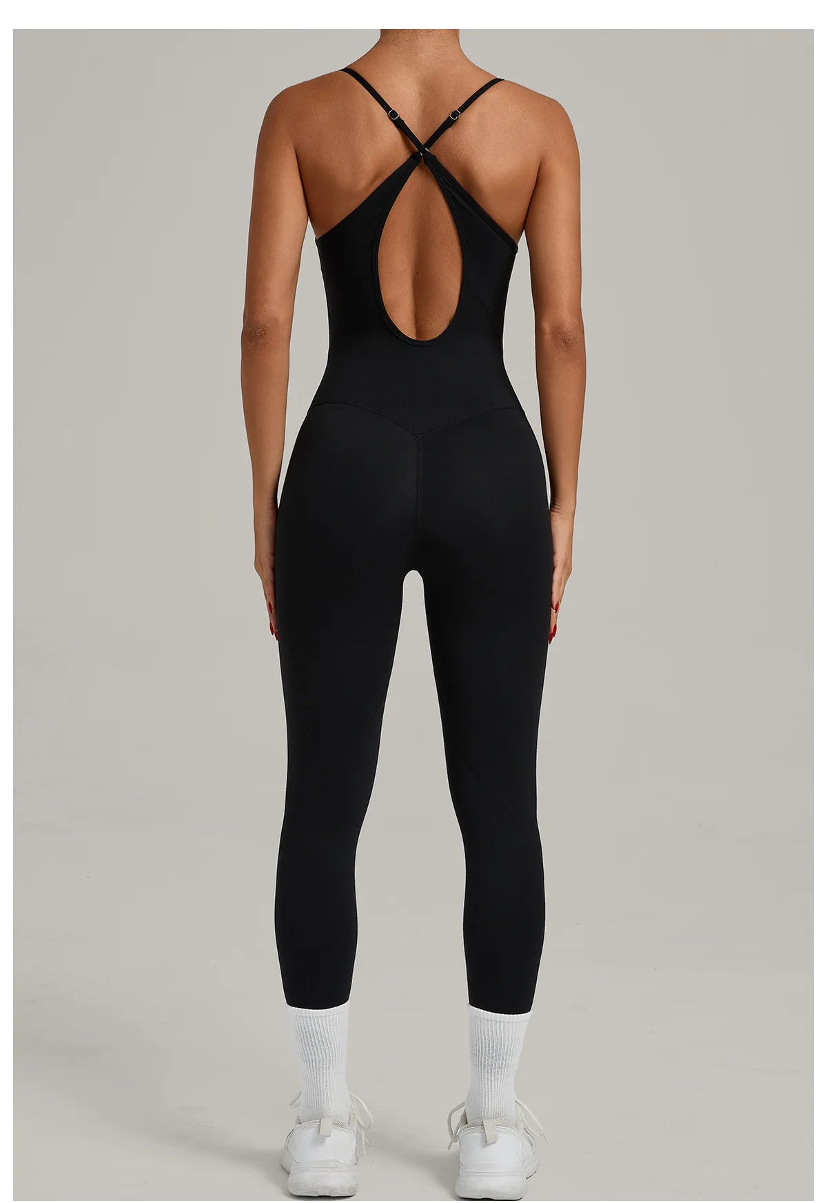 Black yoga jumpsuit with crisscross back straps and oval mid-back cutout