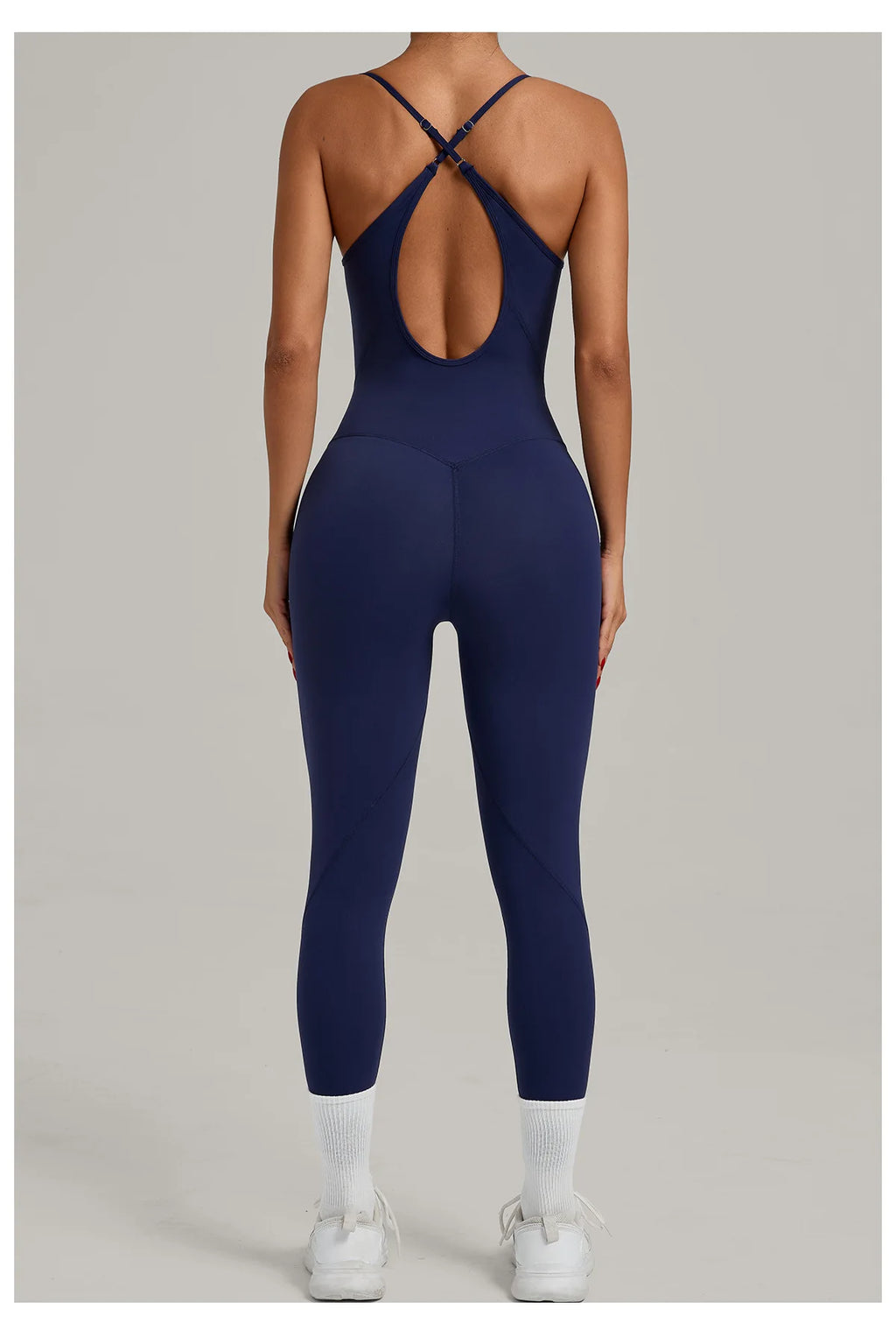 Navy blue sleeveless yoga bodysuit with open-back crisscross detail