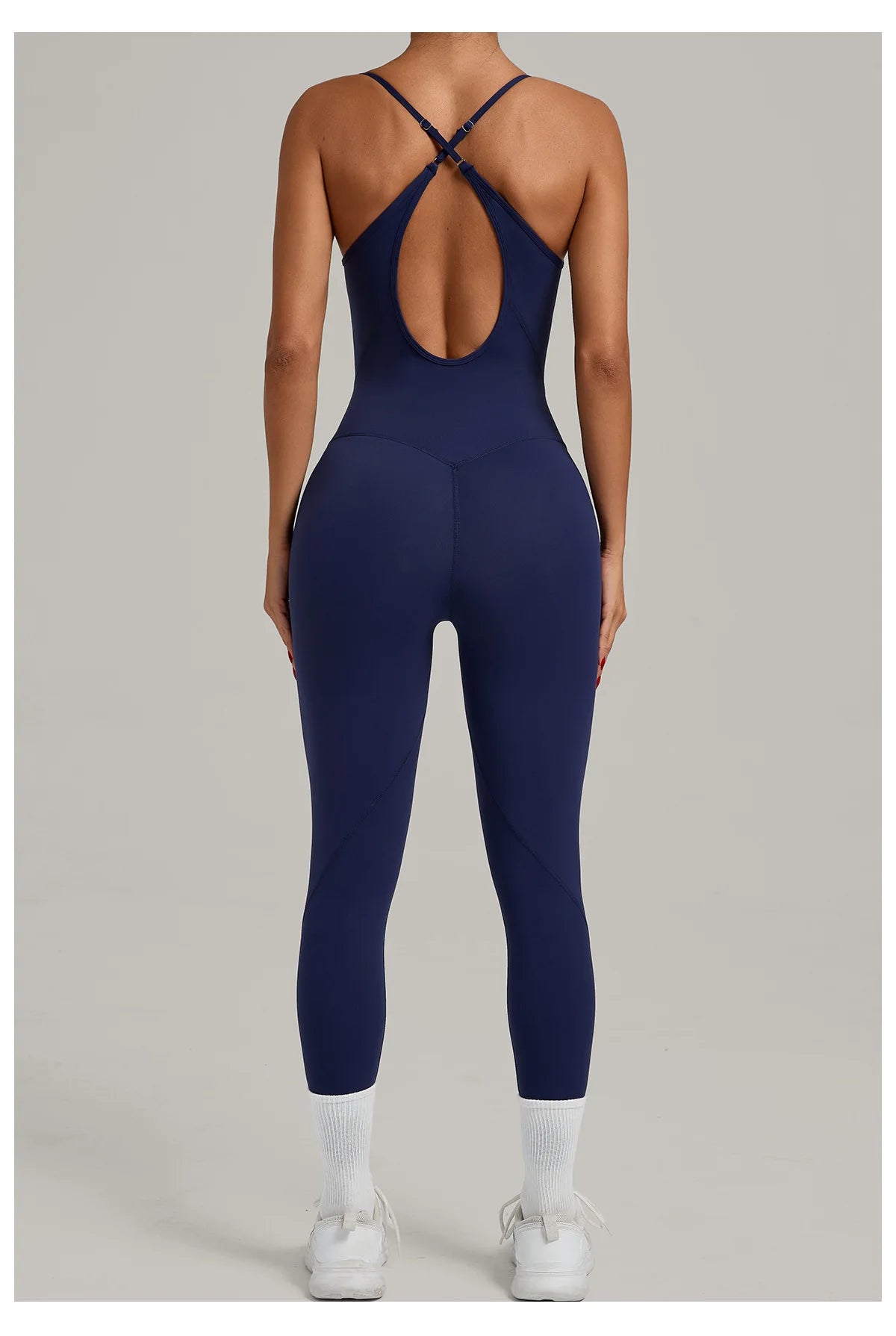Navy blue sleeveless yoga bodysuit with open-back crisscross detail