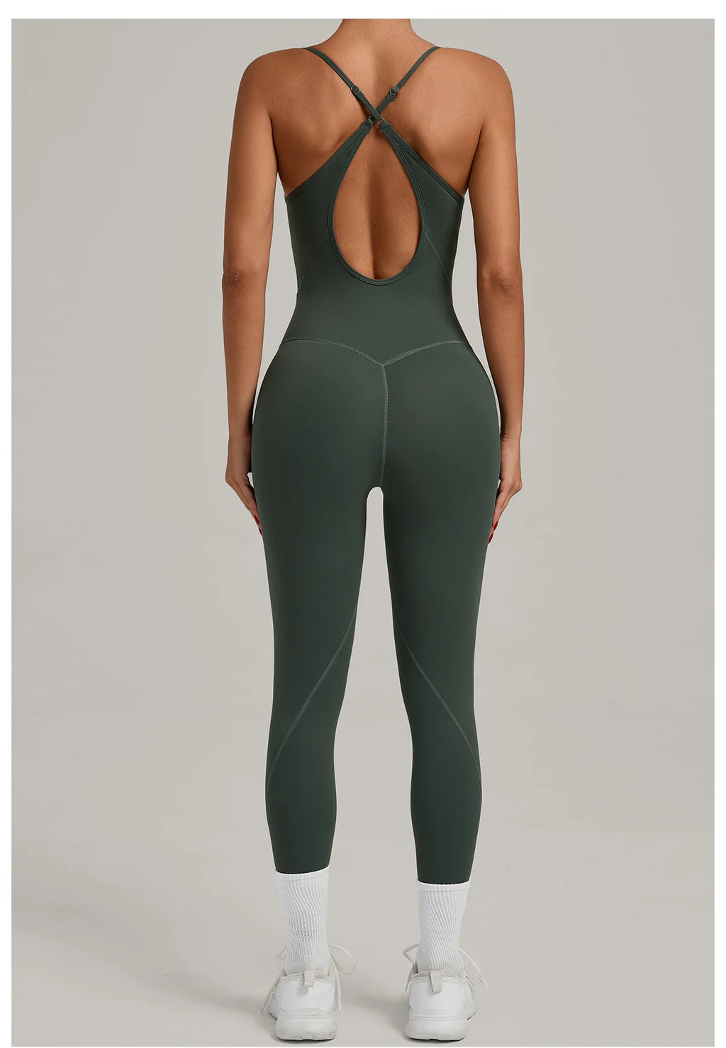 Dark green yoga jumpsuit with cross-back straps and long capri legs