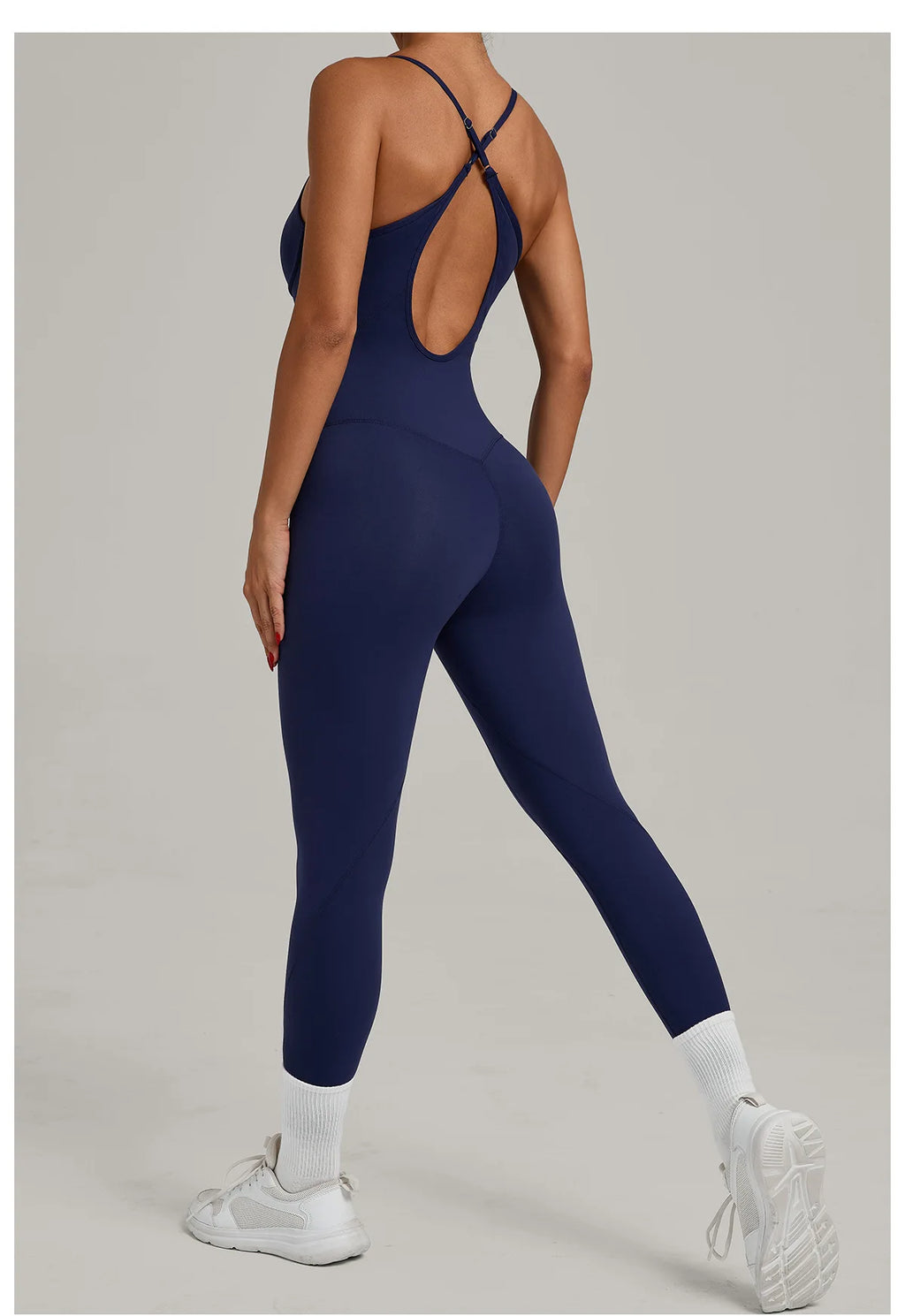 Navy blue one-piece yoga bodysuit with crisscross open back straps