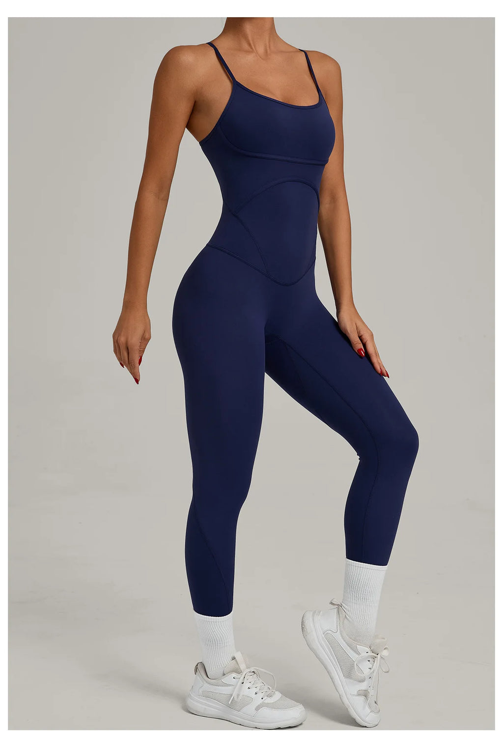 Navy blue one-piece yoga bodysuit with spaghetti straps and fitted legs