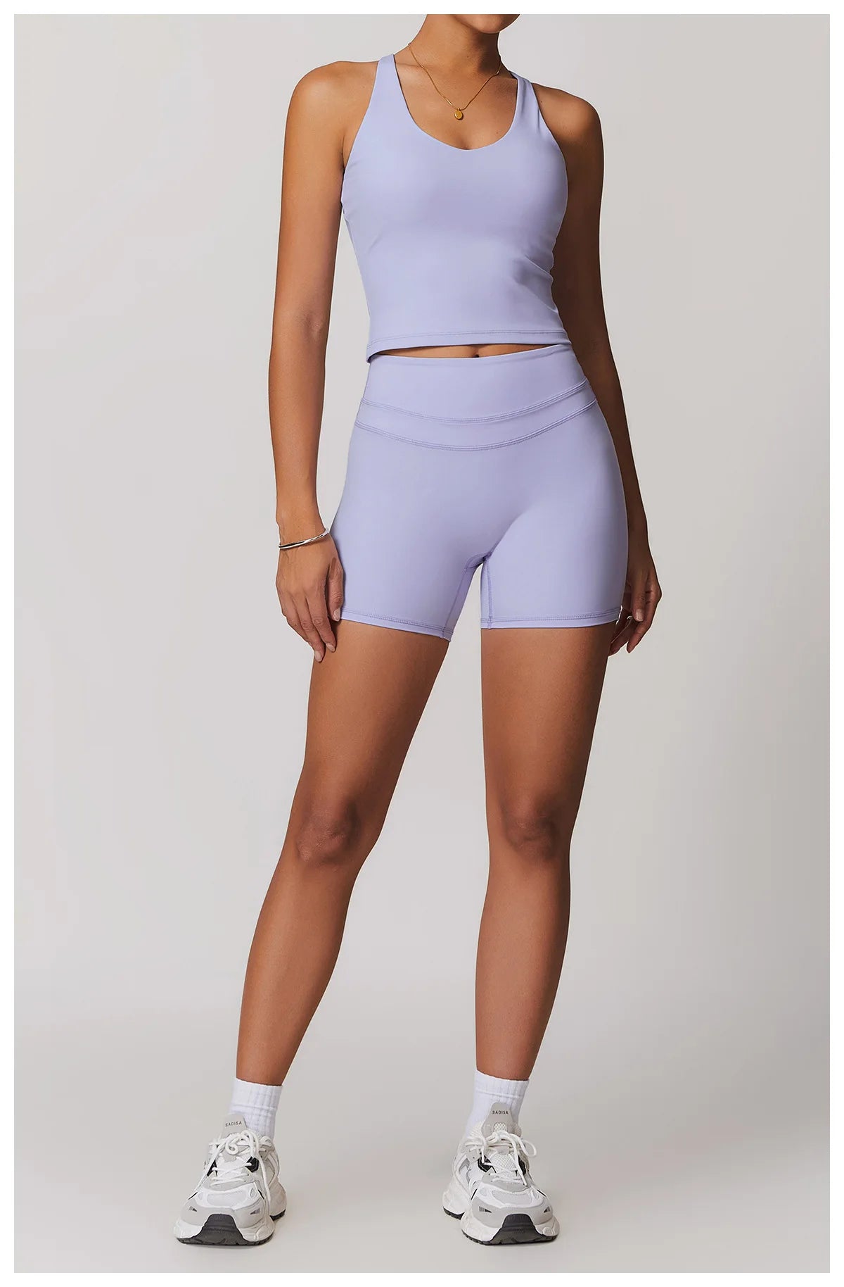 Xooie Fit fitness tank top and biker shorts set in lavender with athletic sneakers