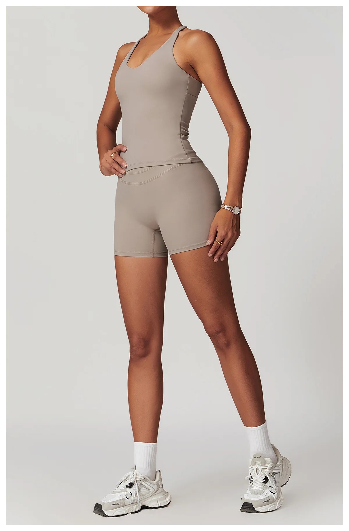 Xooie Fit fitness tank top and biker shorts set in beige modeled with white sneakers and socks