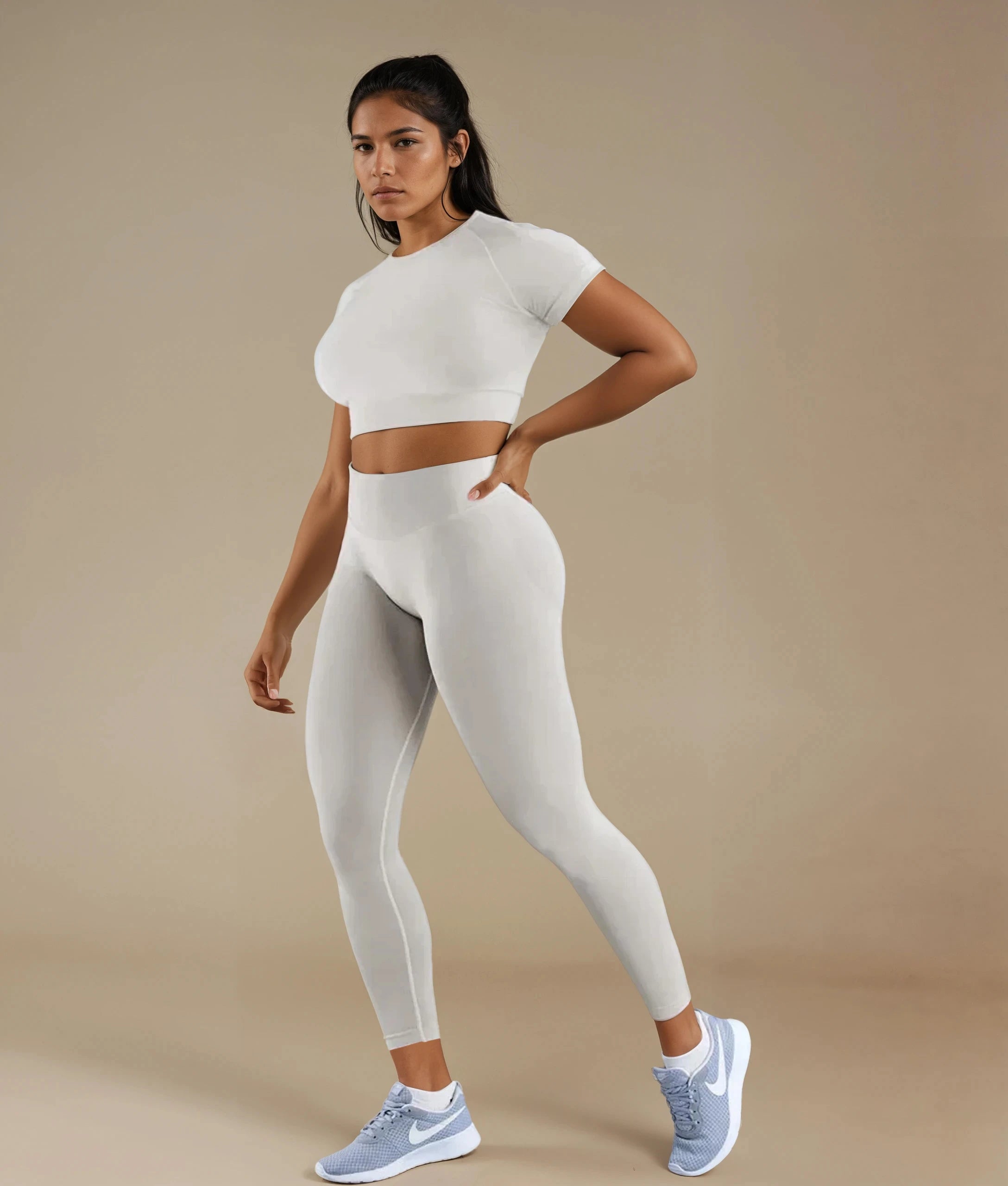 Model wearing a fitted crop top leggings set in light gray from Xooie Fit for activewear enthusiasts