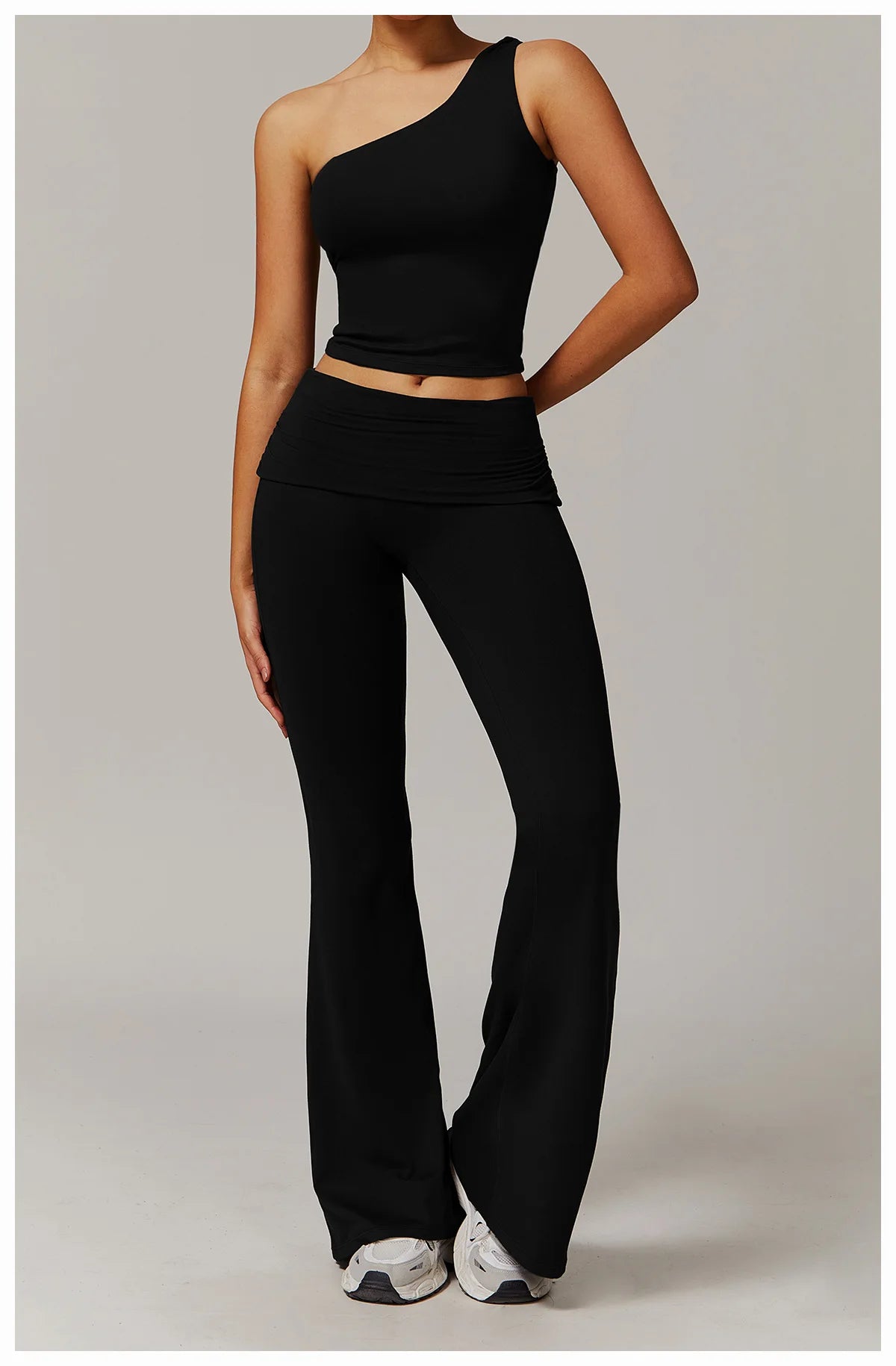 Xooie Fit black flare leg workout set with one-shoulder crop top and high-waisted flared pants