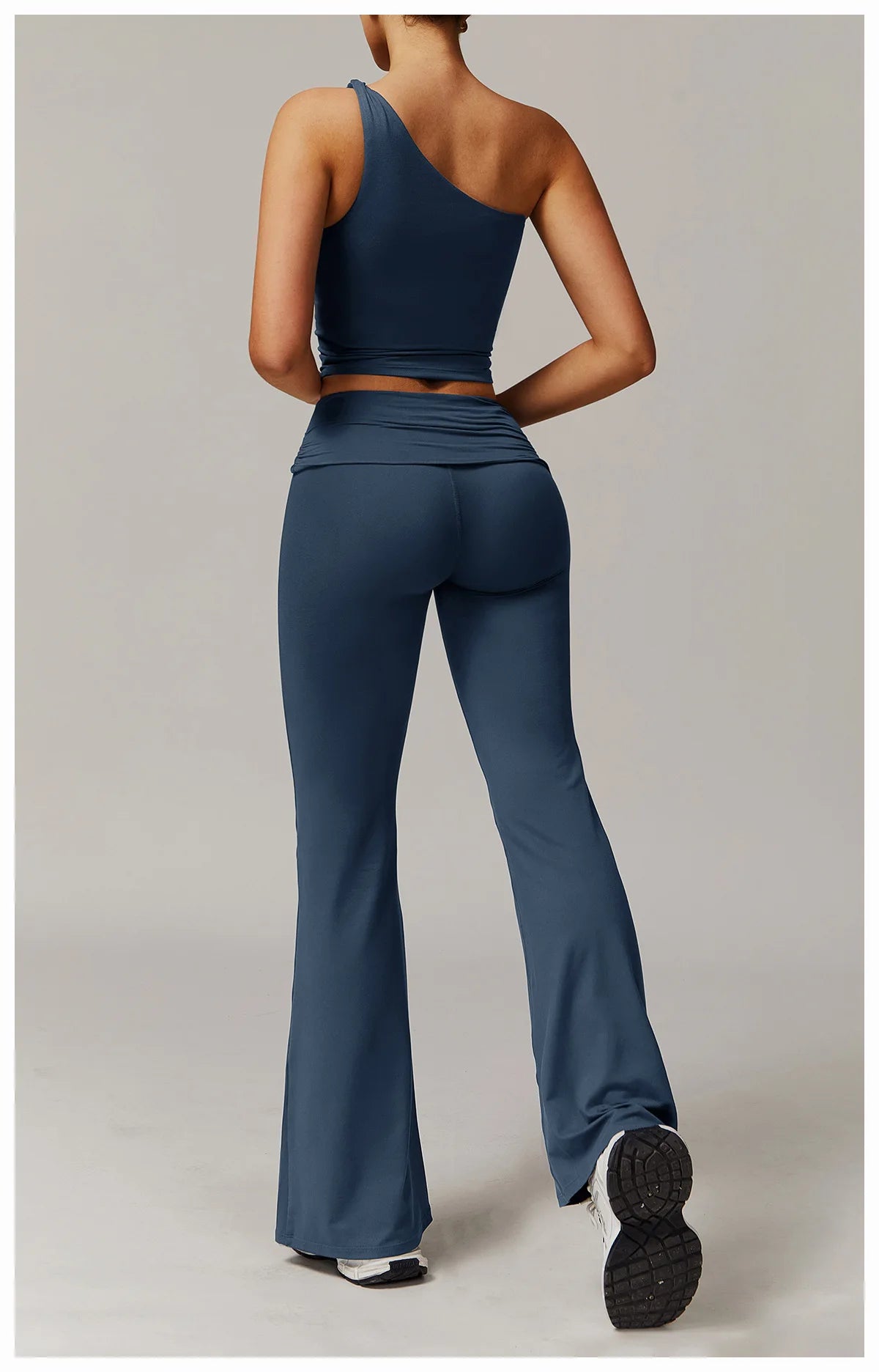 Xooie Fit two-piece flare leg workout set in blue featuring a one-shoulder top and flared pants