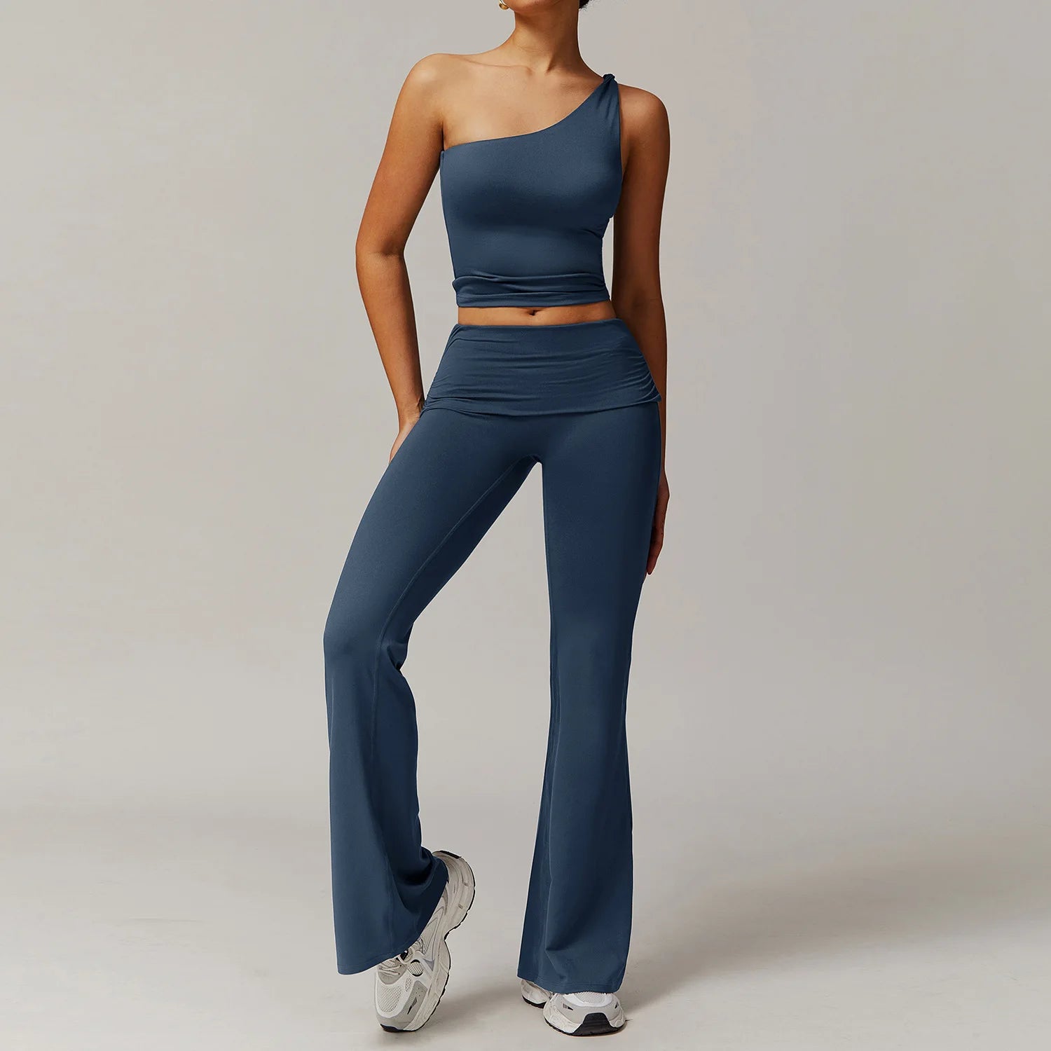 Xooie Fit flare leg workout set in dark blue featuring a one-shoulder crop top and high-waist flared pants