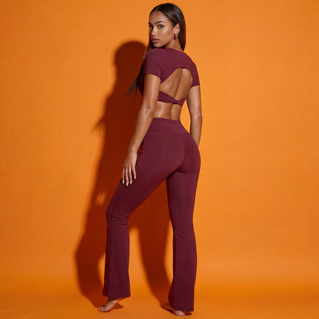 Maroon set shown from the back: twist backless crop top and flared pants