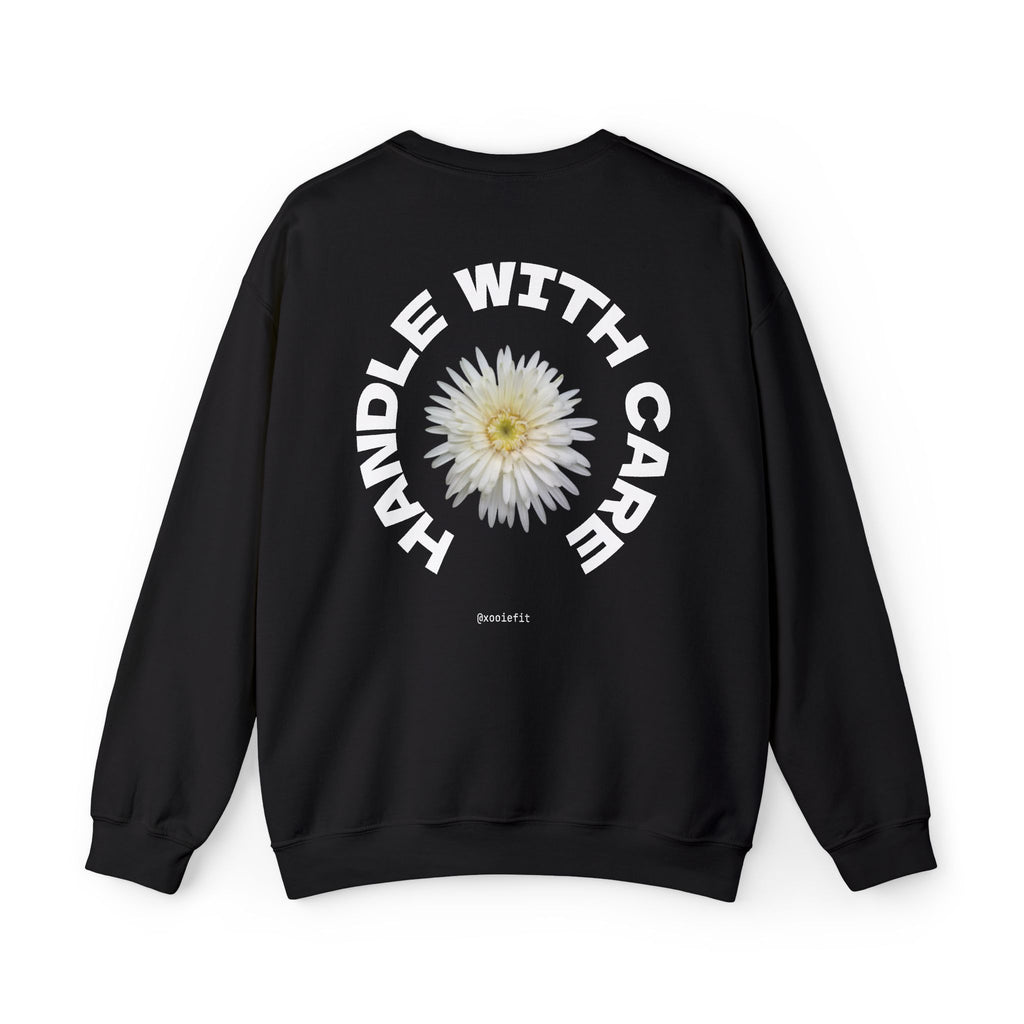 Black crewneck sweatshirt, back view showing circular "WITH CARE" daisy print