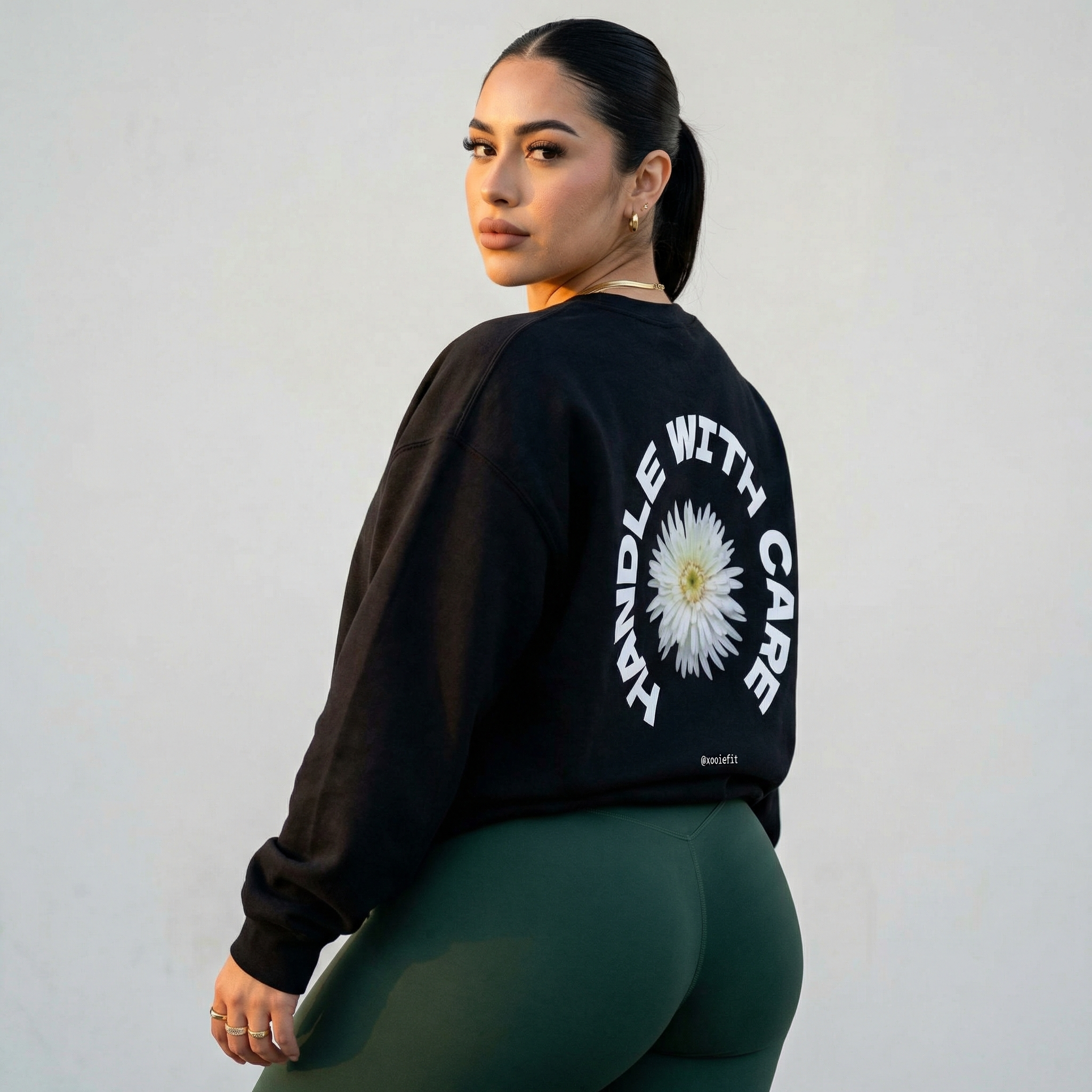 Black crewneck sweatshirt, large back daisy logo and circular white text