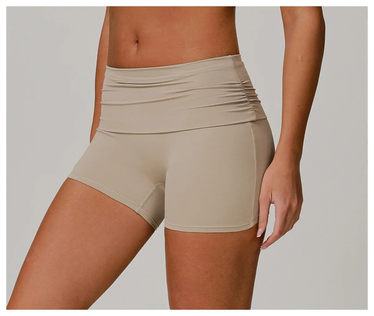 Xooie Fit beige foldable waistband yoga shorts with a high-rise design and comfortable fit