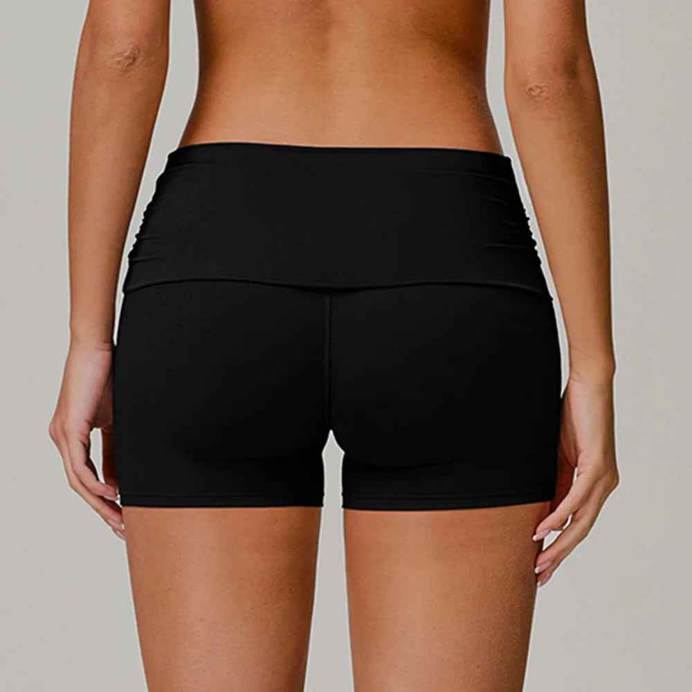 Xooie Fit black foldable waistband yoga shorts shown from the back on a model