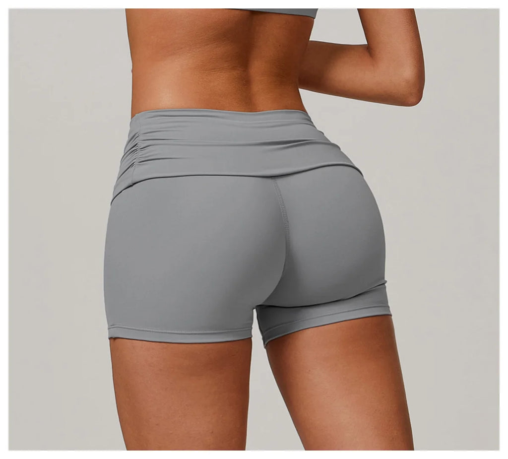 Xooie Fit foldable waistband yoga shorts in gray shown from the back on a model