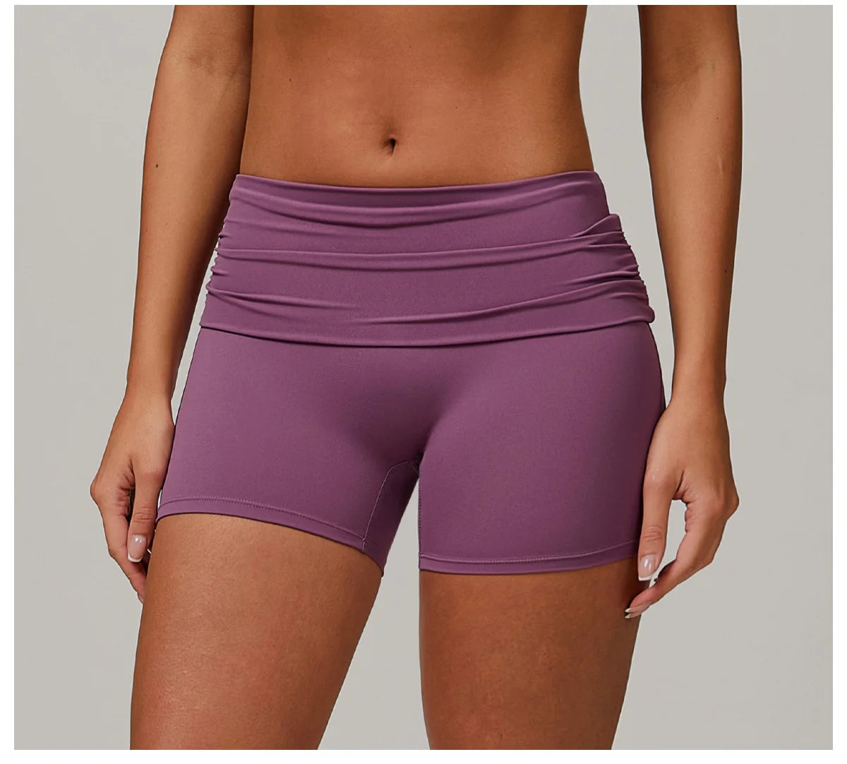 Xooie Fit purple foldable waistband yoga shorts on female model for comfortable workout