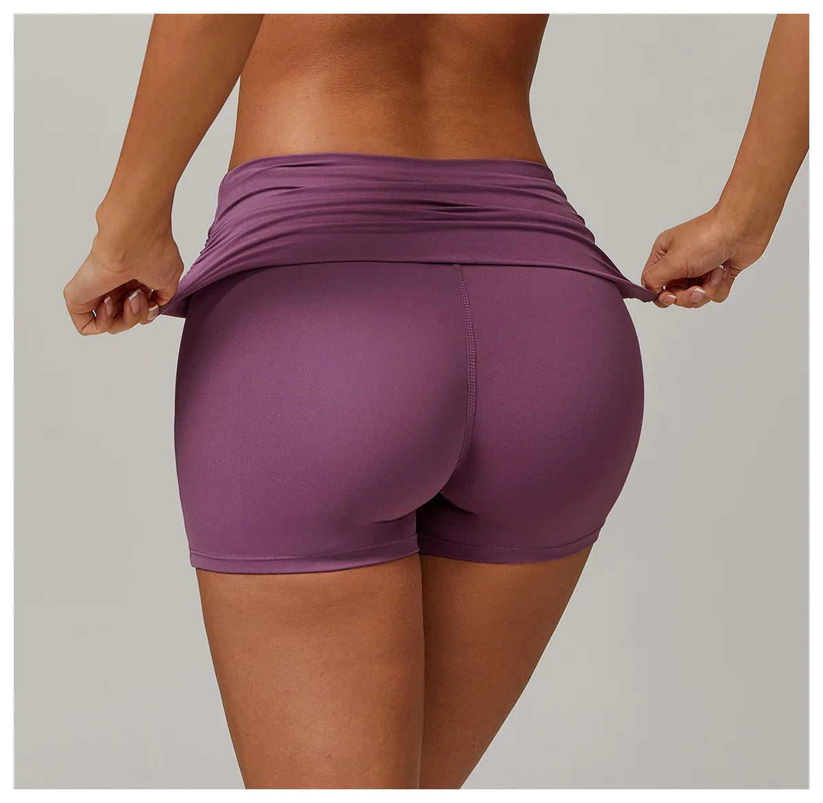 Xooie Fit purple foldable waistband yoga shorts shown from back on model