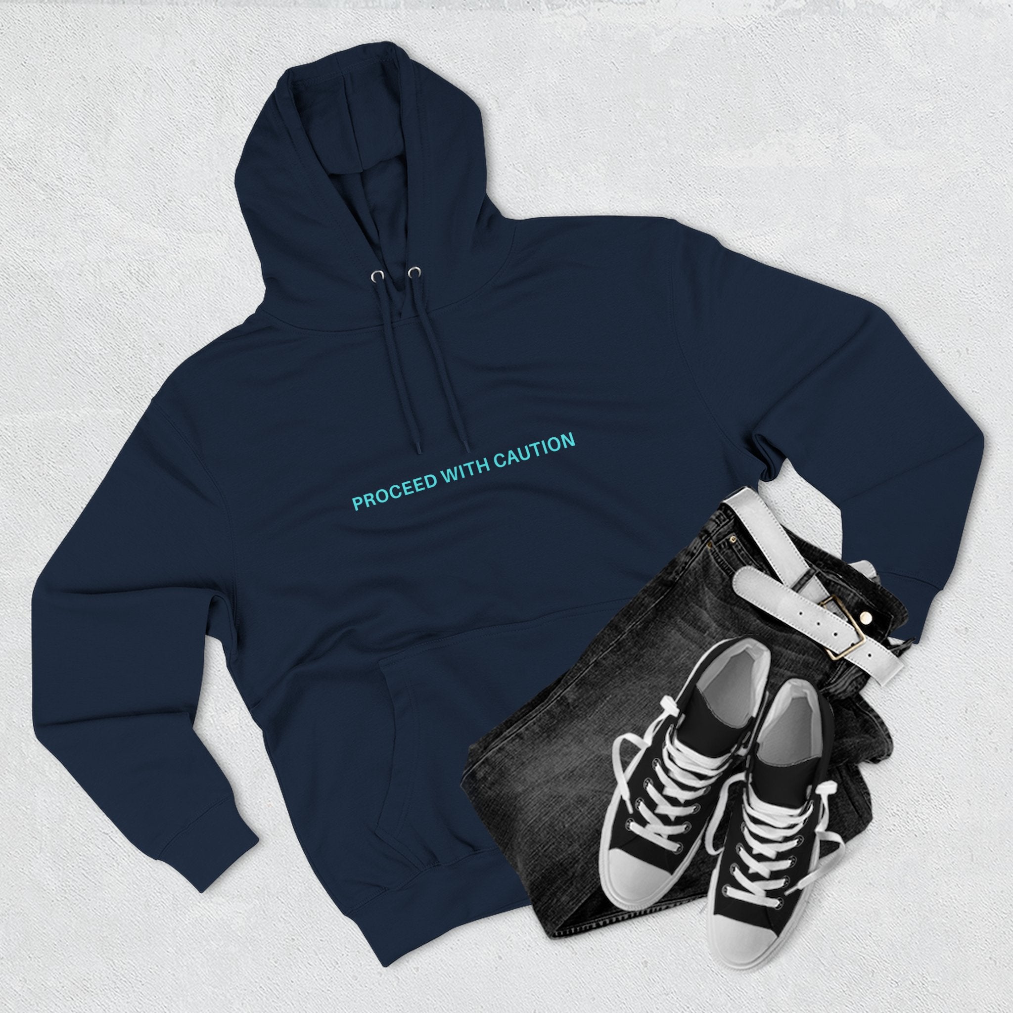 Navy blue hoodie with front chest text “PROCEED WITH CAUTION”