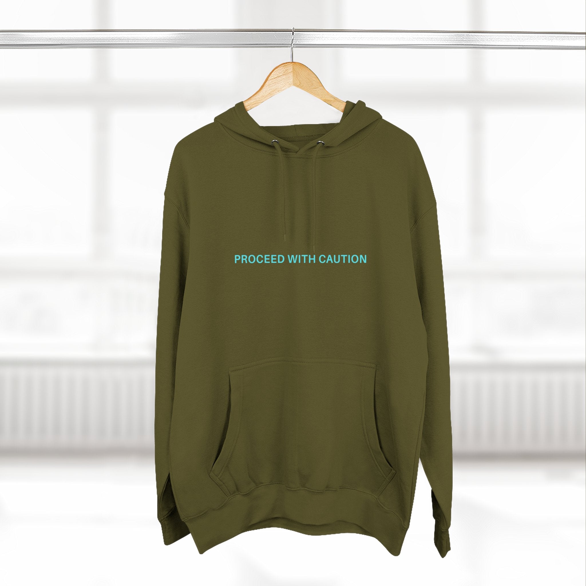 Graphic fleece hoodie, army green front on hanger with “Proceed With Caution” text