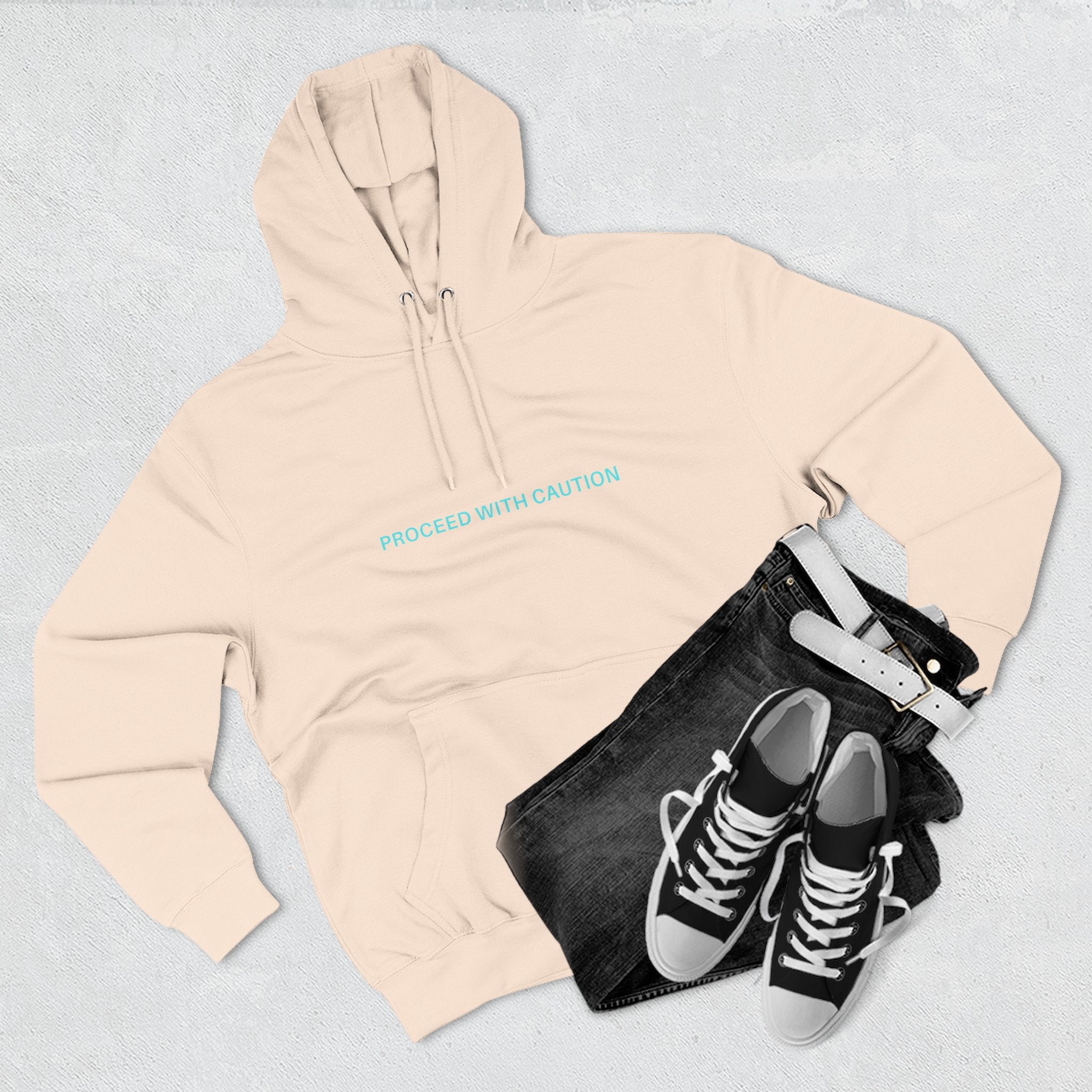 Off-white hoodie with front chest text “PROCEED WITH CAUTION”