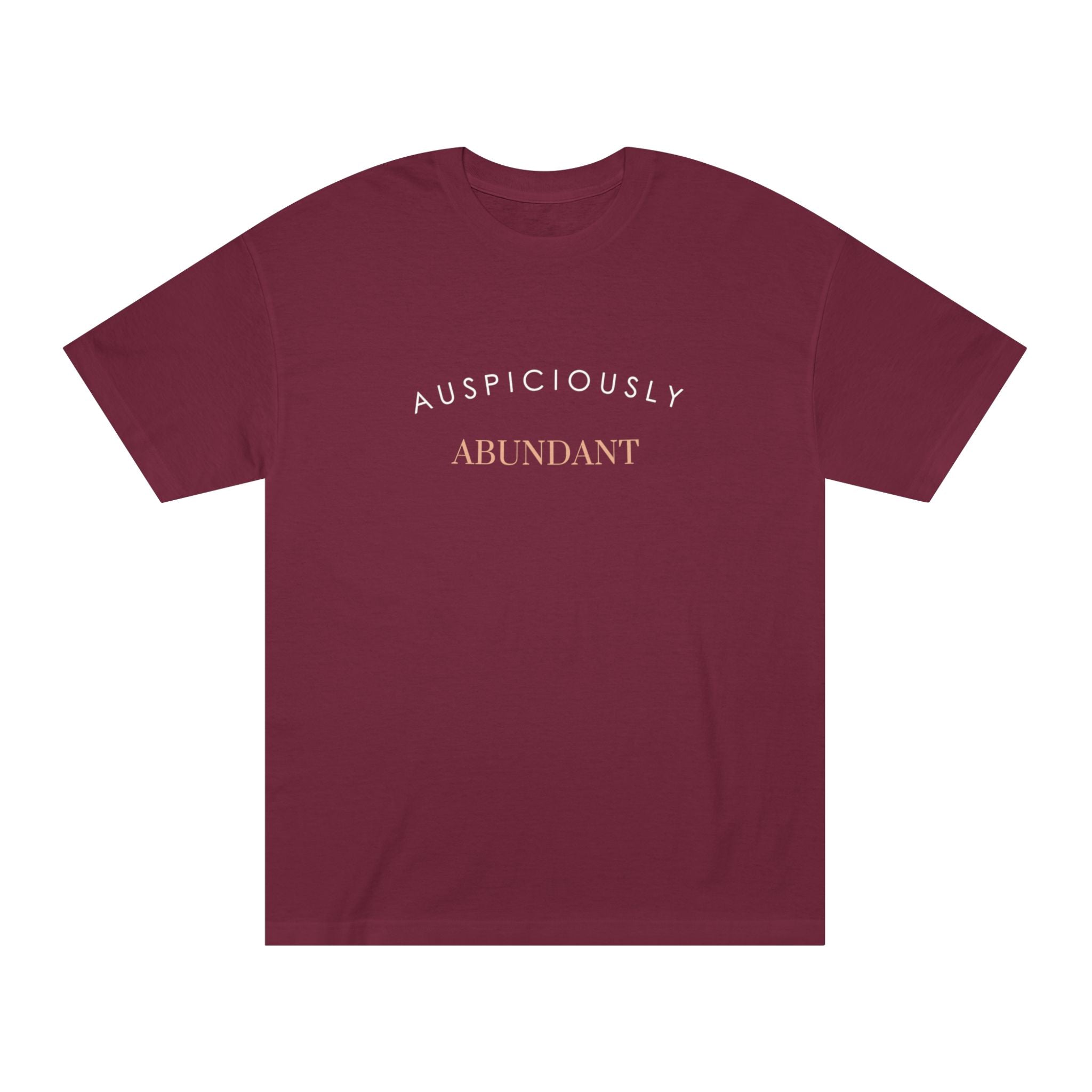 Burgundy crewneck tee with gold “Auspiciously Abundant” text graphic on front