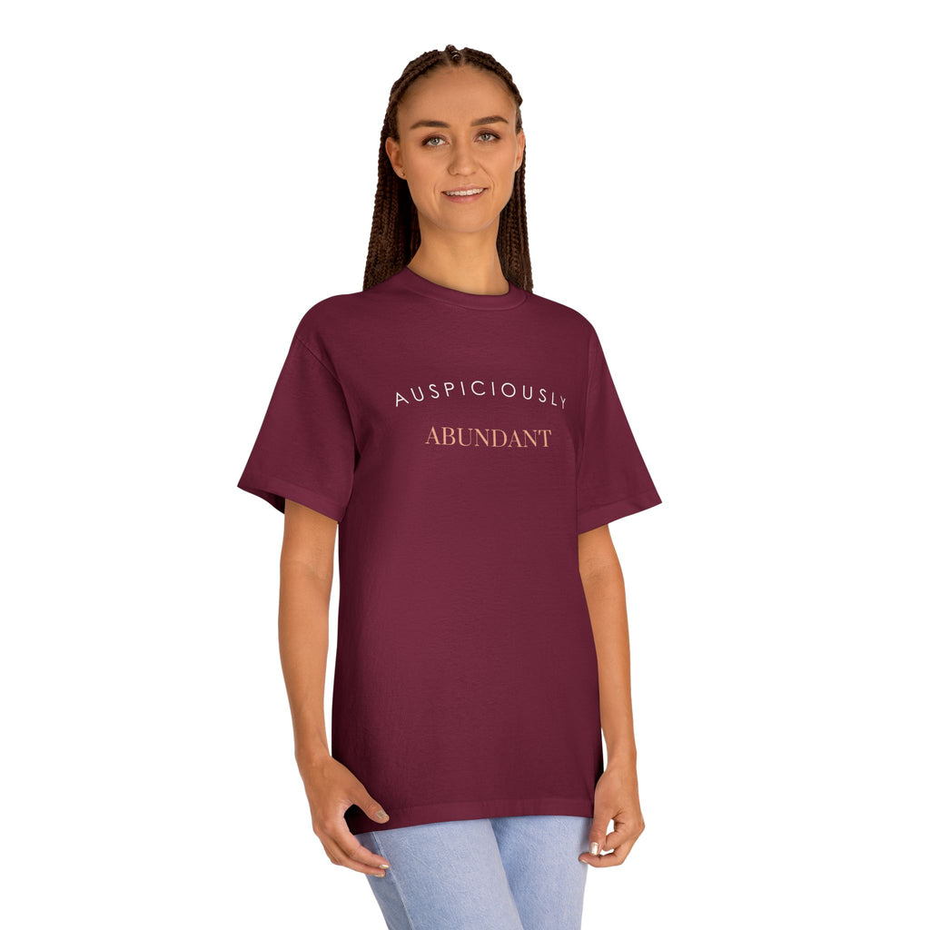 Burgundy crewneck tee with 'Auspiciously Abundant' text graphic across chest