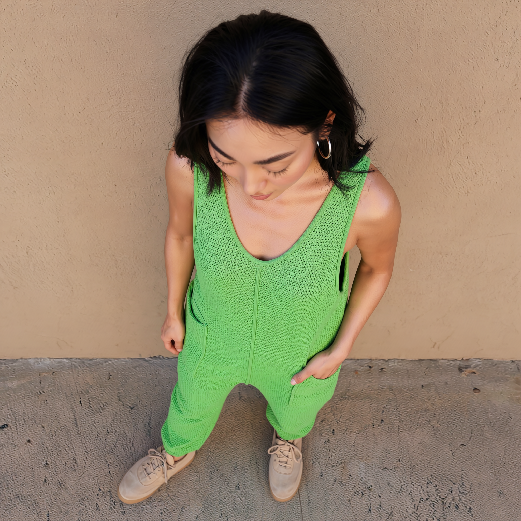 Green knit sleeveless pocket jumpsuit with wide legs and scoop neckline