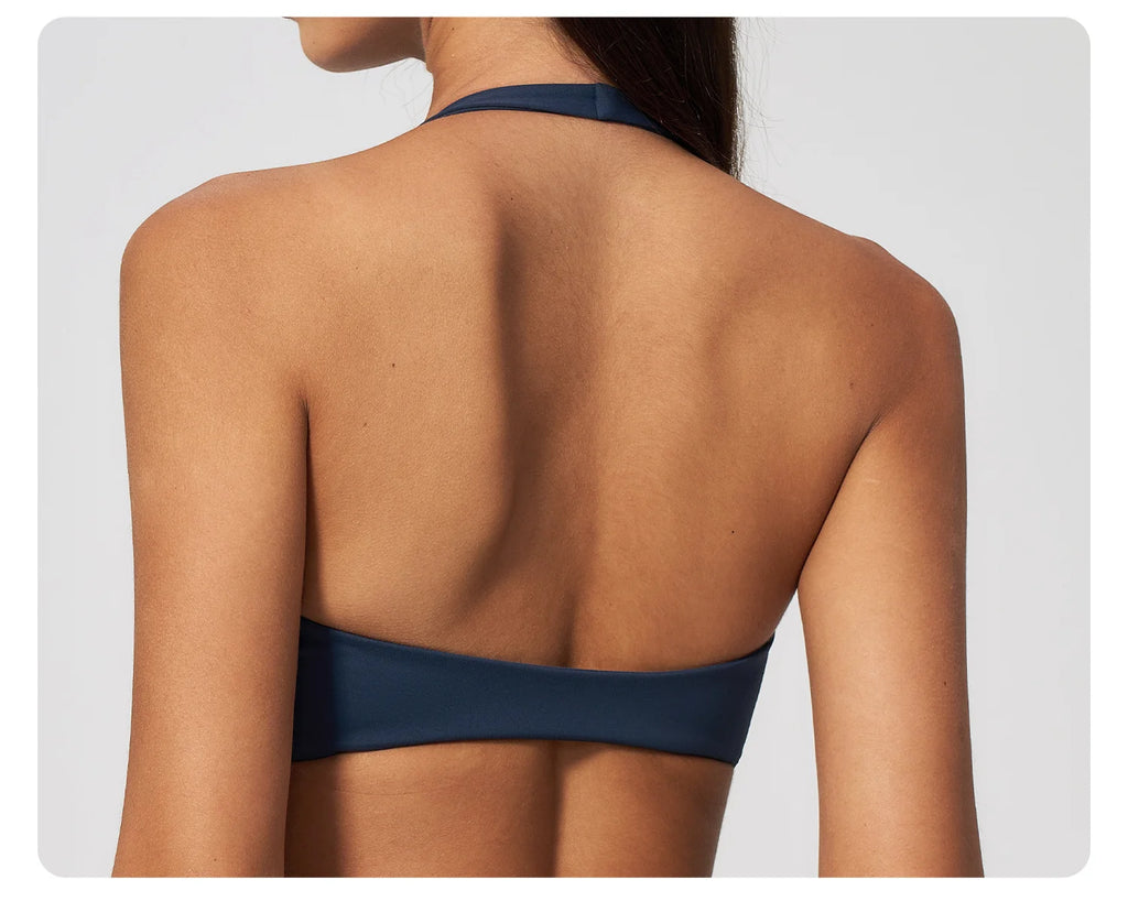Back view of badge blue halter yoga sports bra with open back and wide band