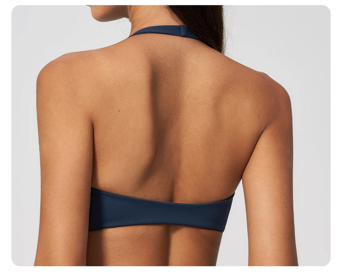 Back view of badge blue halter yoga sports bra with open back and wide band