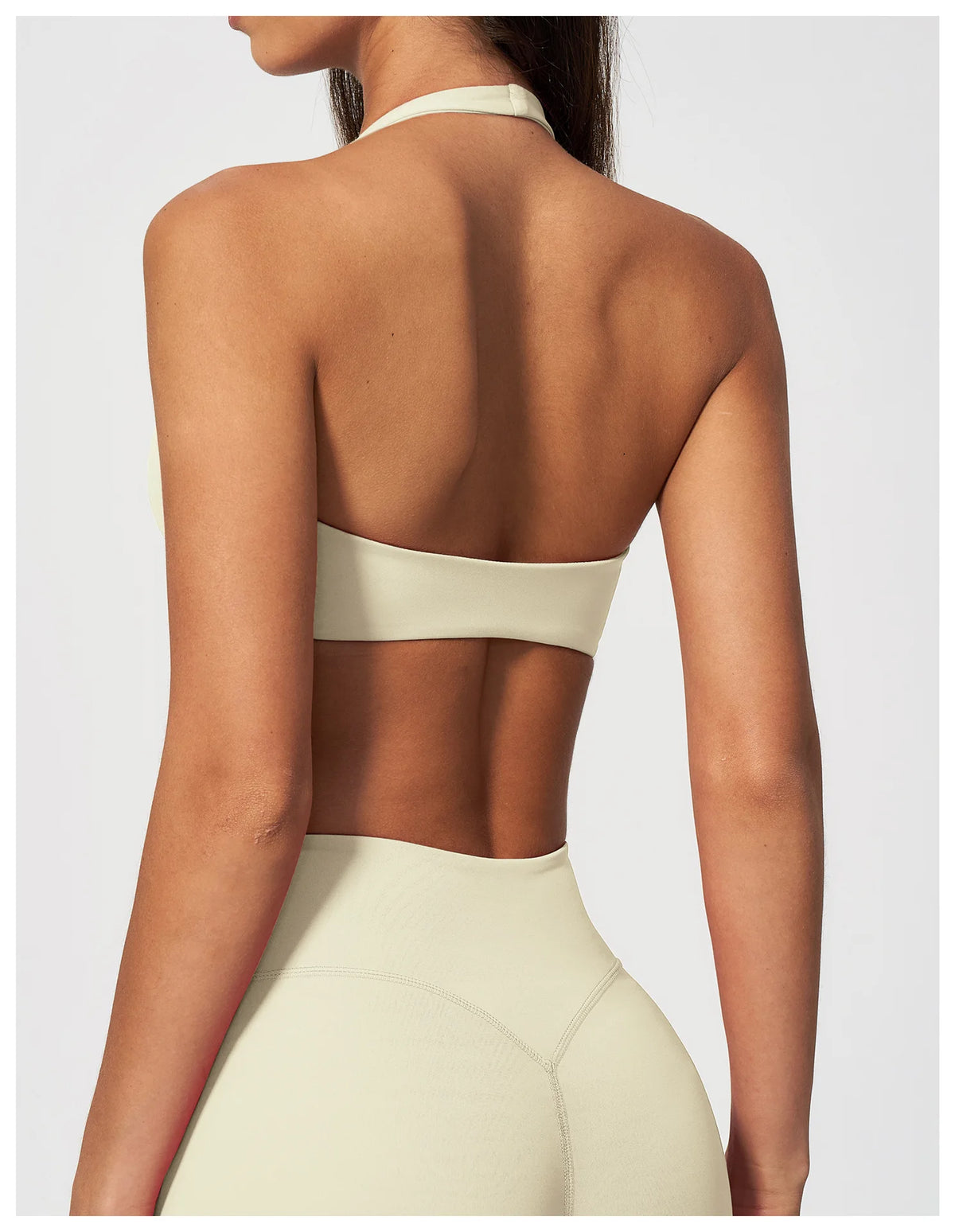 Back view of creamy white halter yoga bra with open back band