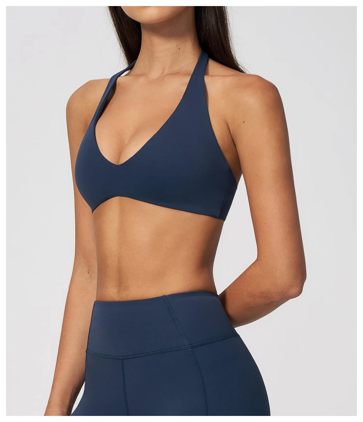 Dark blue halter yoga bra with plunging V neckline and open back styling