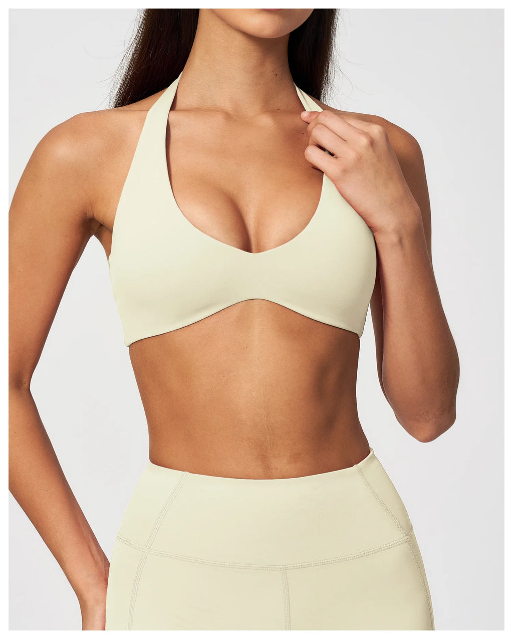 Creamy white halter neck yoga bra with racerback-style cut and scoop front
