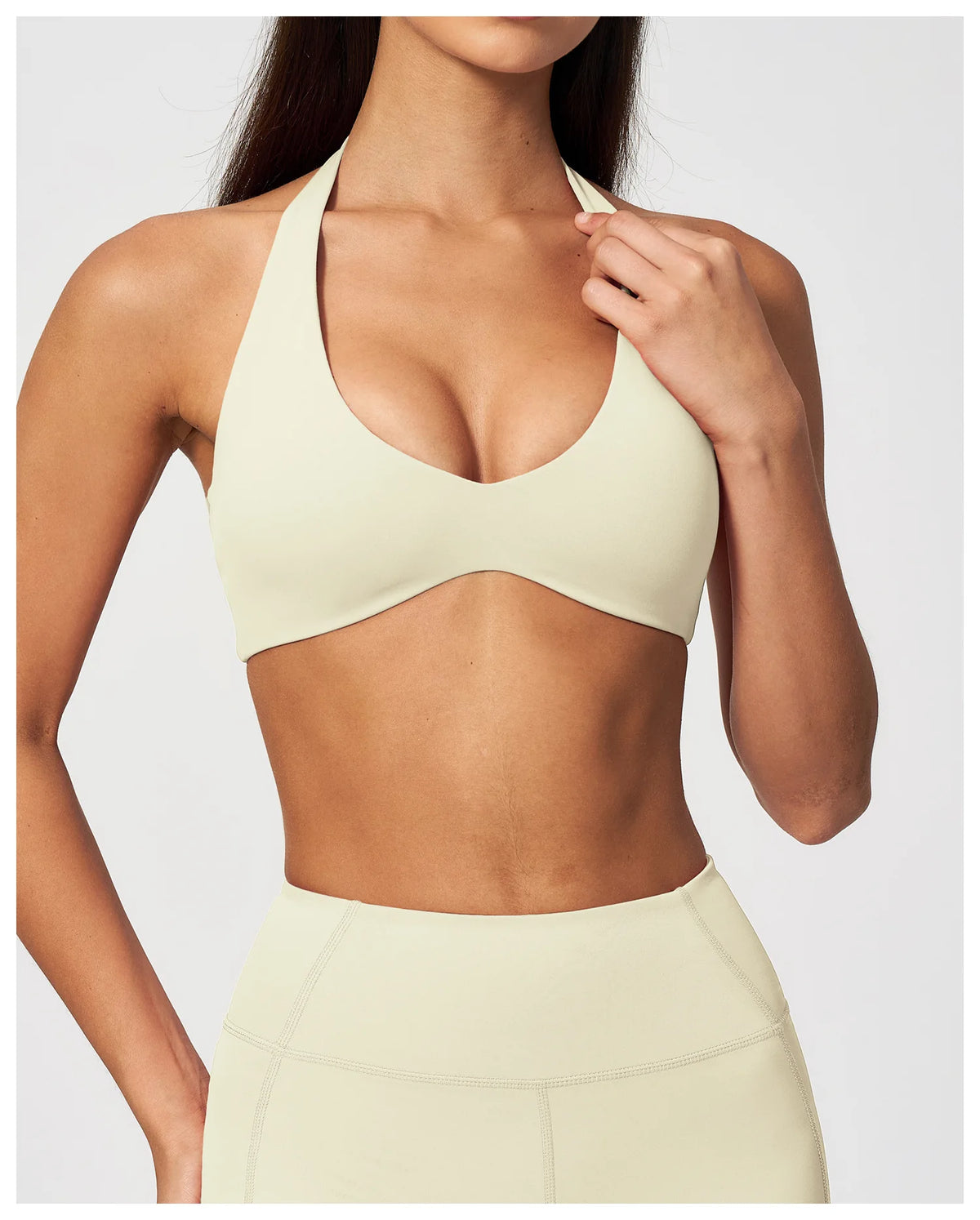 Creamy white halter neck yoga bra with racerback-style cut and scoop front