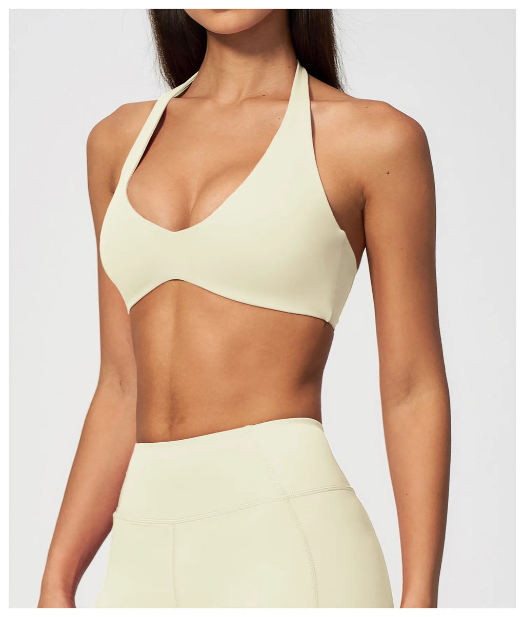 Creamy white halter yoga bra with plunging V neckline and slim halter strap