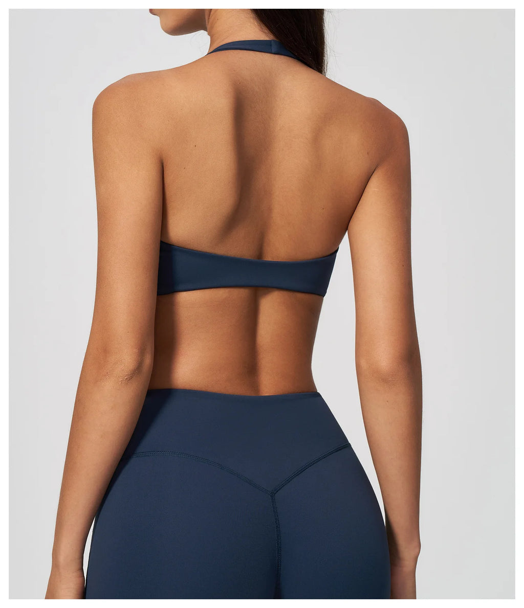 Dark blue back view of halter yoga bra with open back and banded support