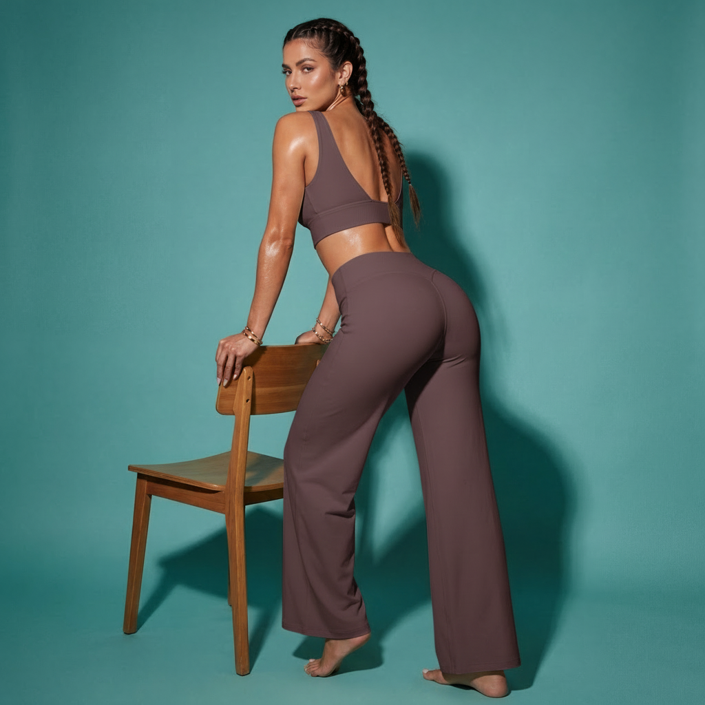 Dark purple crop bra top and flare pants matching set, seated side view