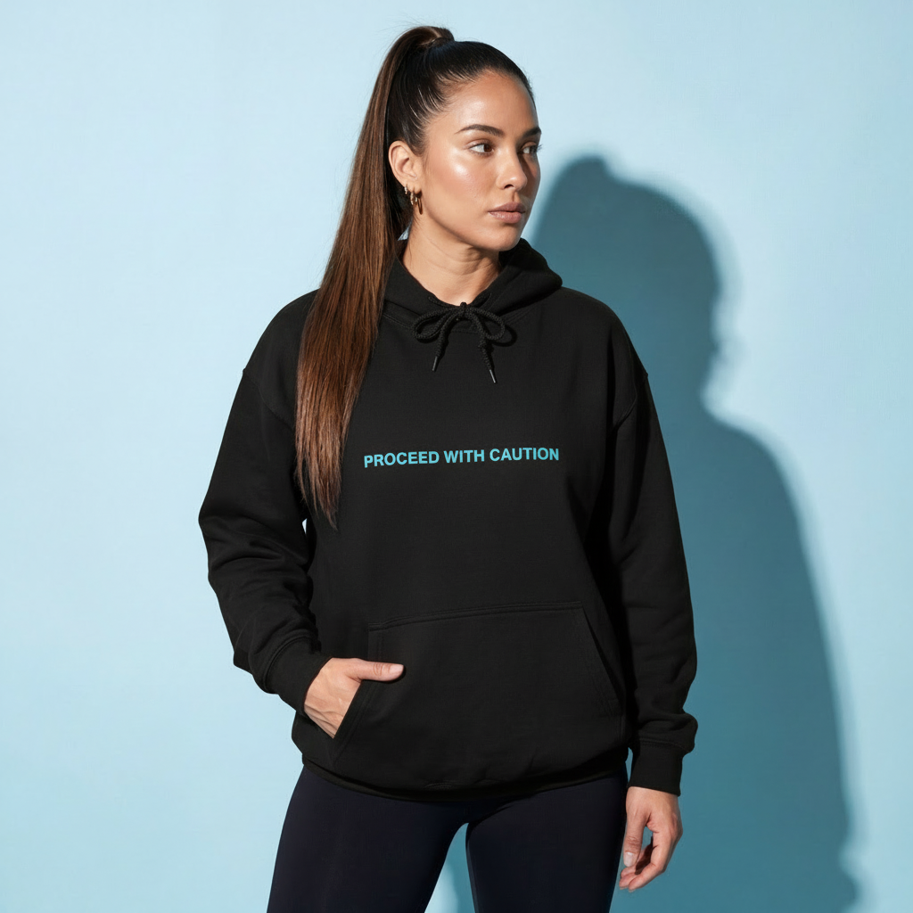 Graphic fleece hoodie, black front with “Proceed With Caution” text and kangaroo pocket