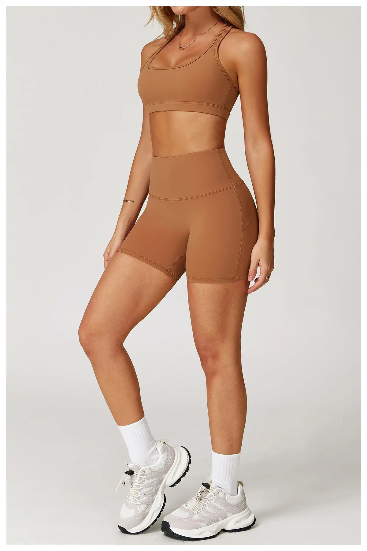 Xooie Fit two-piece set in brown featuring high-performance activewear crop top and shorts