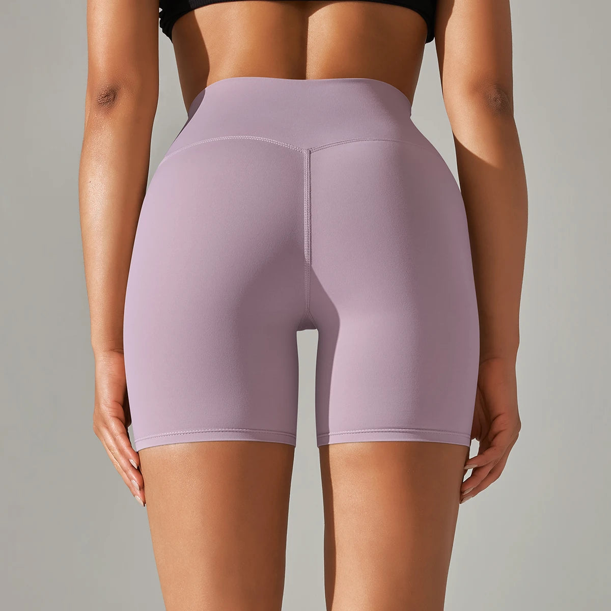 Xooie Fit high quality active shorts for women in light purple shown from the back on a model