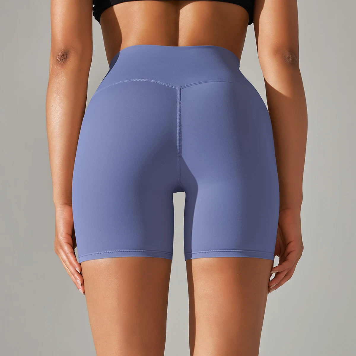 Back view of woman wearing Xooie Fit high quality active shorts in blue with high waistband