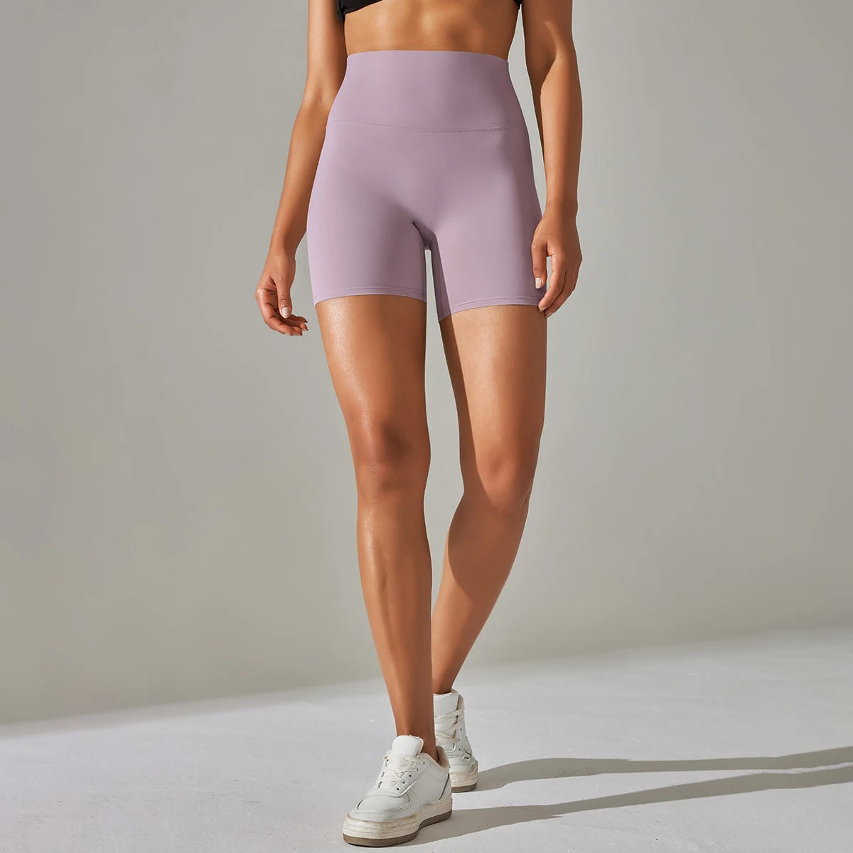 Xooie Fit high quality active shorts in lavender worn by woman with white sneakers