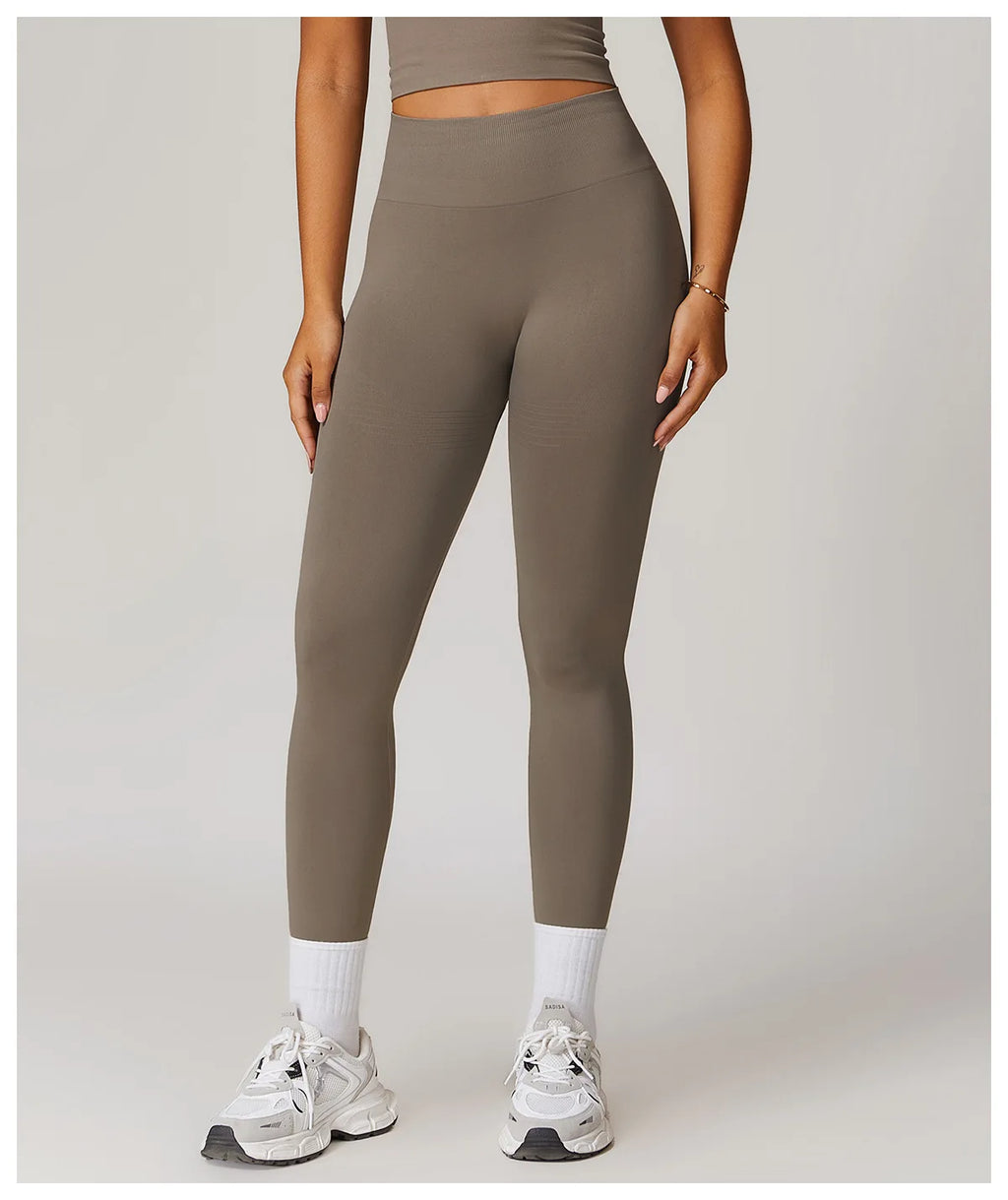 High-waisted active leggings in light gray, ankle-length fit with supportive stretch
