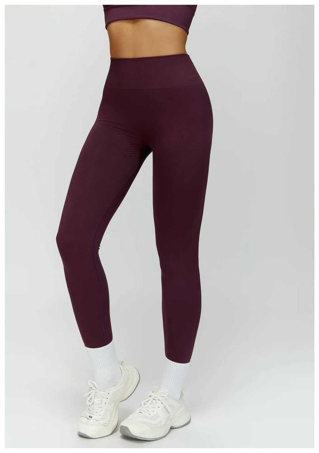 Plum purple high-waisted active leggings, close front view with sculpted hips