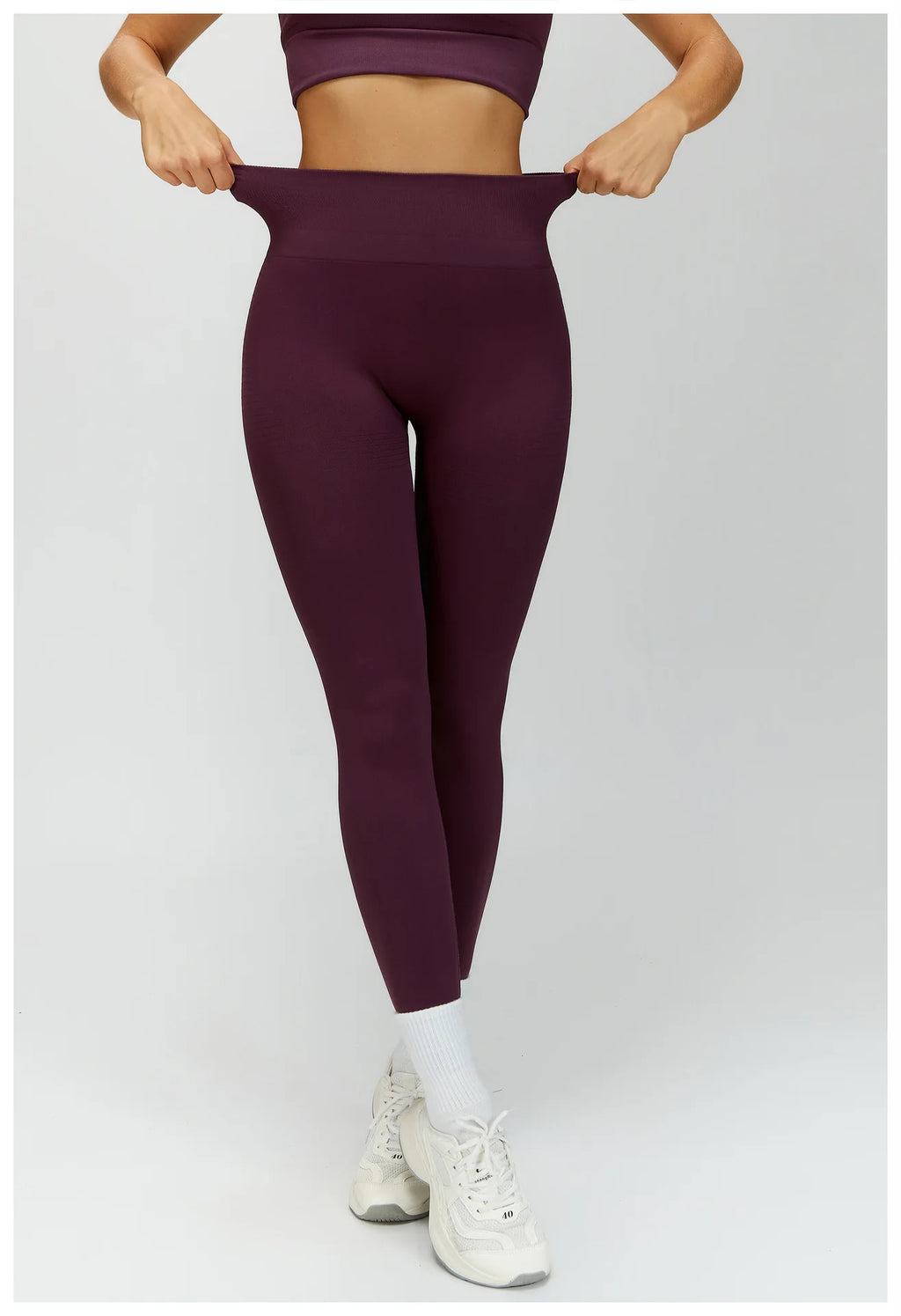Plum purple high-waisted active leggings, front view with tapered ankle