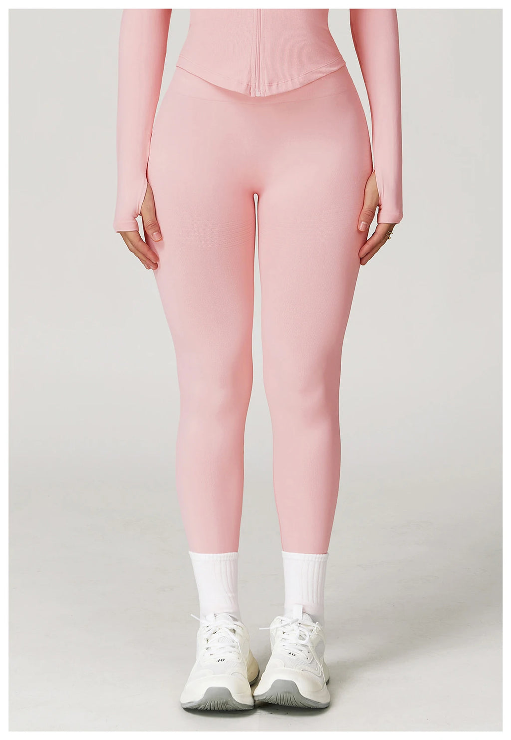 Light pink high-waisted active leggings, snug fit with seam detail at front