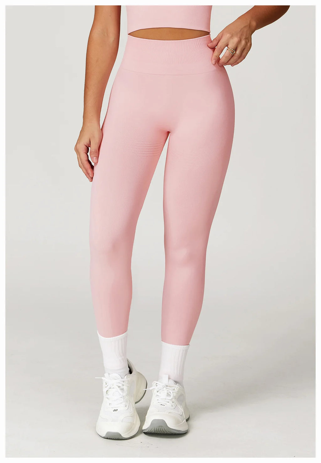 Light pink high-waisted active leggings, front view with cutout waistband detail
