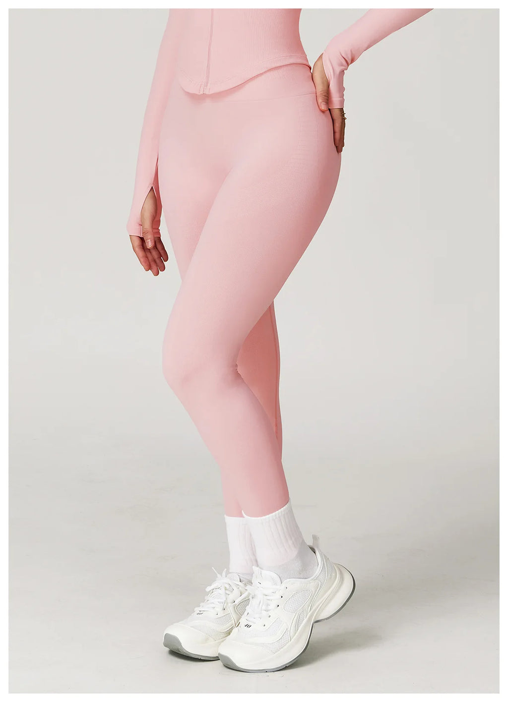 Light pink high-waisted active leggings with side slit at the hem