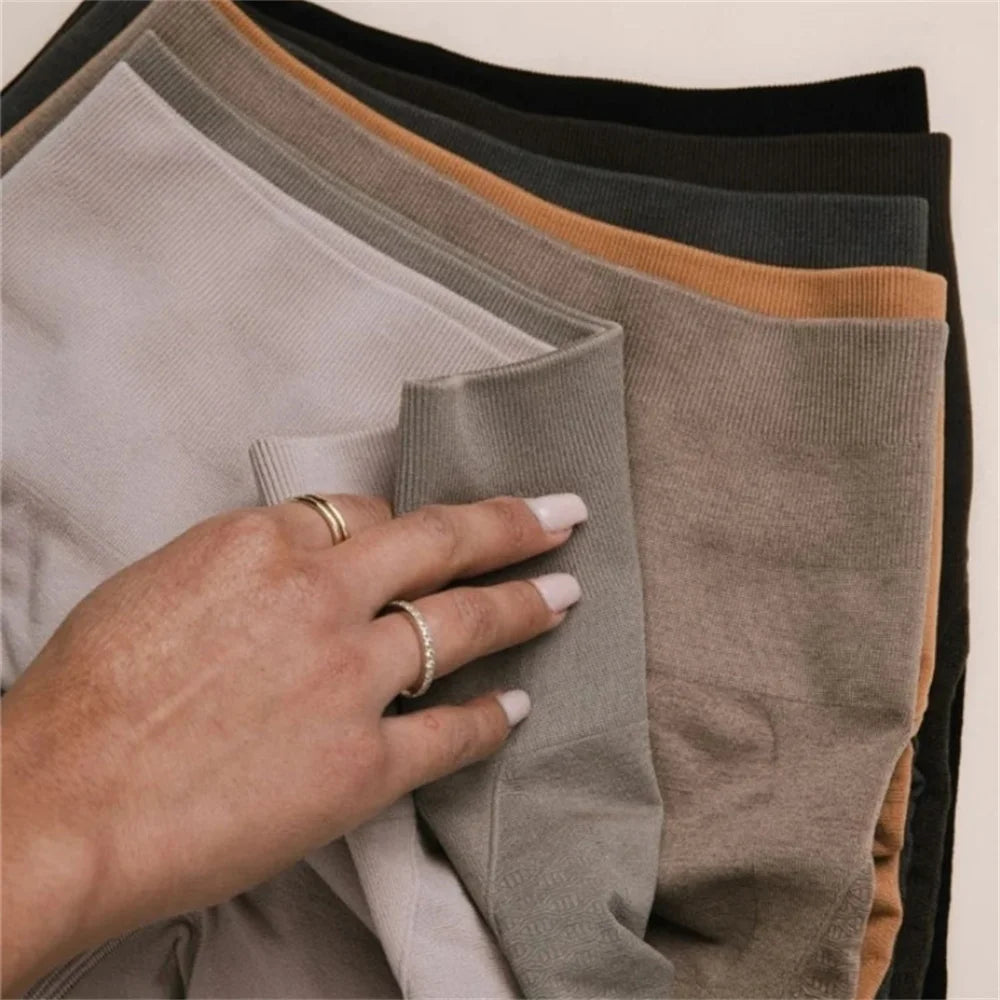 Xooie Fit high waisted active leggings in various colors stacked together for stylish workouts