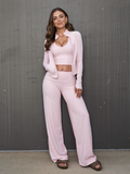 Women’s 3-piece lounge set with cropped tank, jacket, and flare pants in pale pink