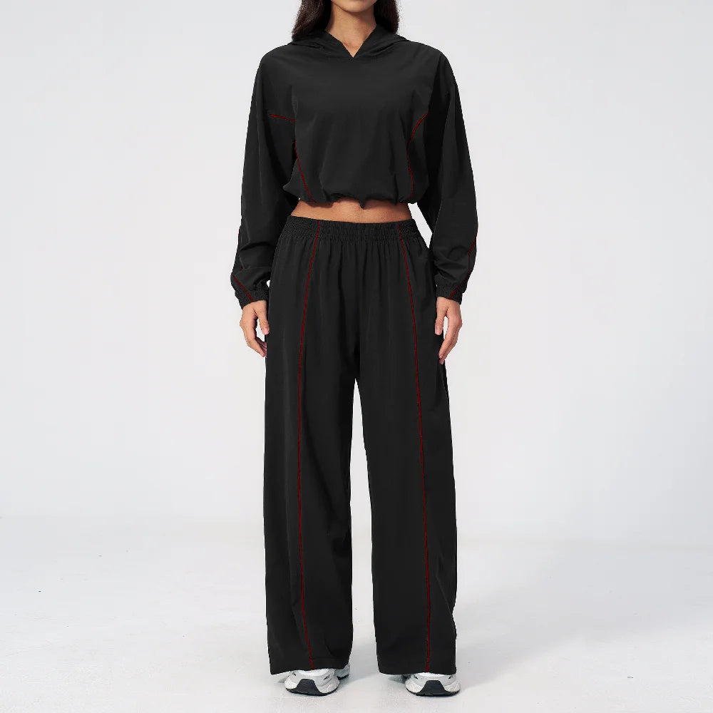 Women’s black hooded windbreaker set with red trim, cropped top and wide-leg pants
