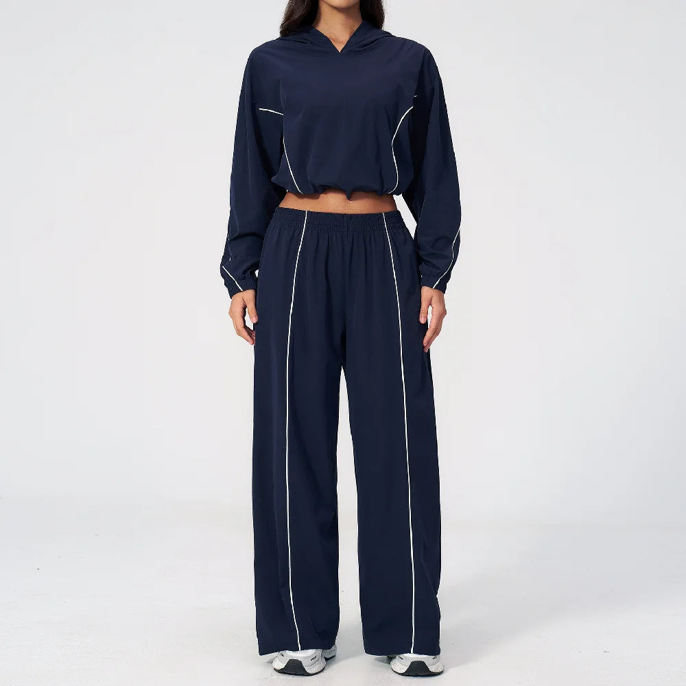Women’s navy hooded windbreaker set with white piping, cropped top and wide-leg pants